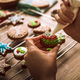 Person icing holiday cookies